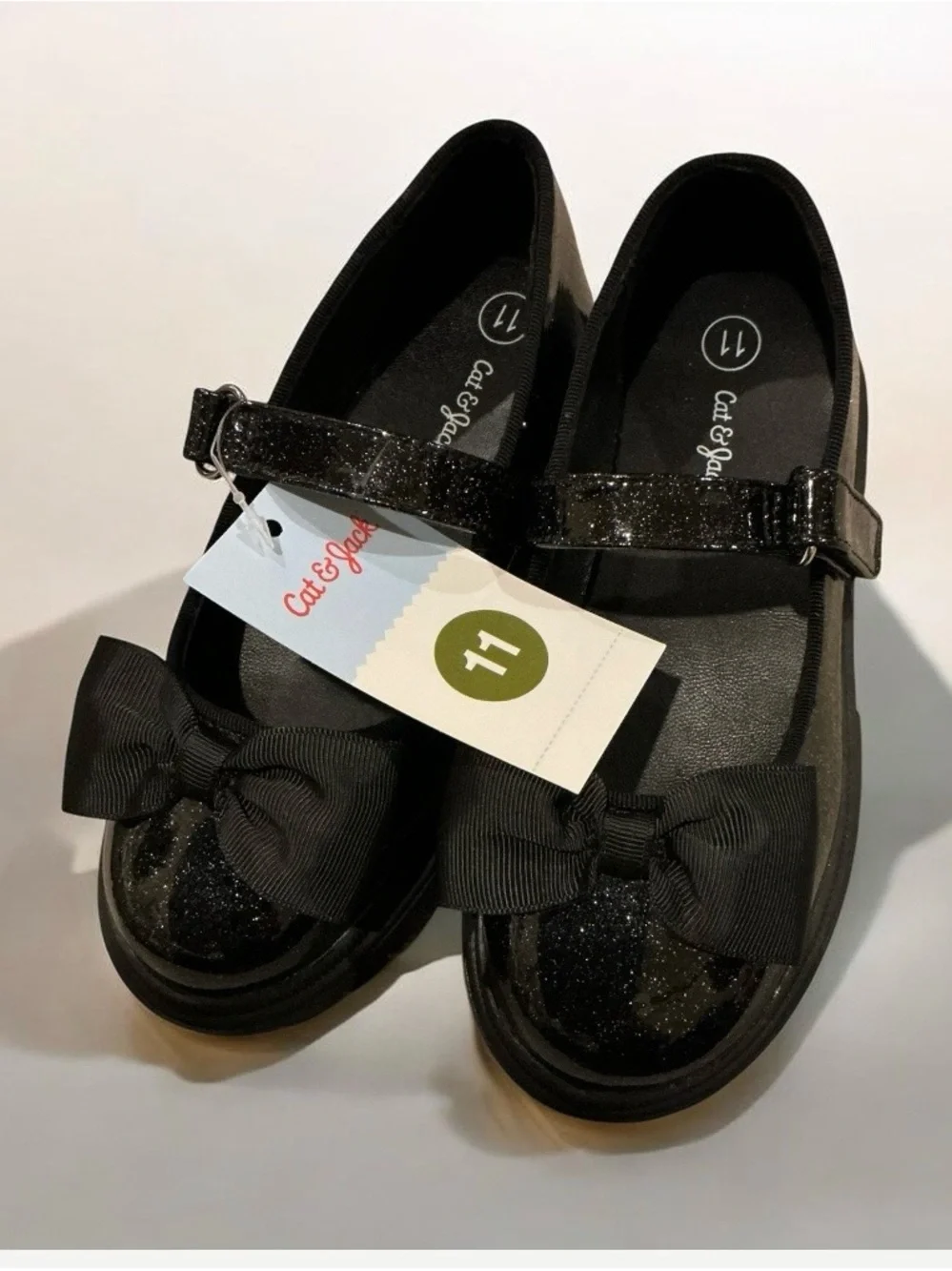 Buy one get one 50% off Cat & Jack Black Glitter Mary Jane Shoes with Bow Accent